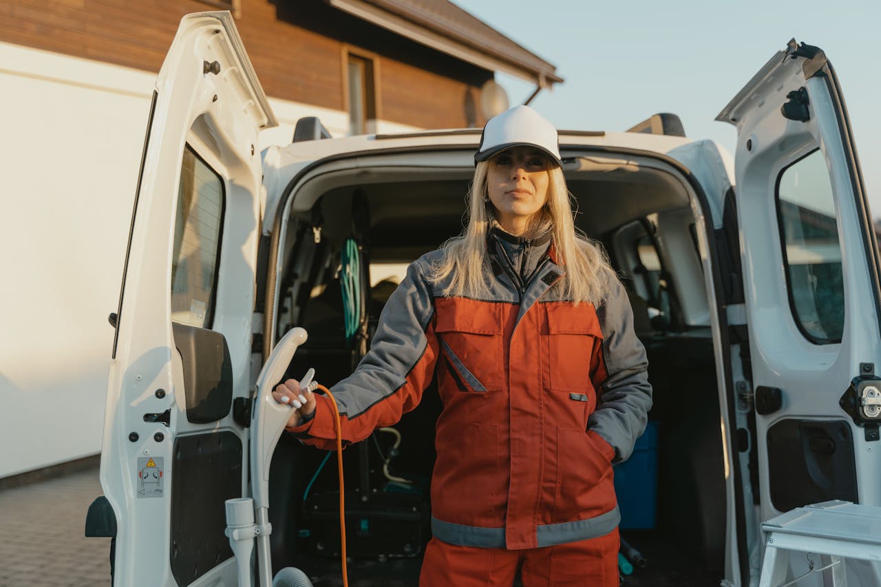 Crafting Captivating Headlines: Your awesome post title goes here Female worker in uniform standing by a cleaning service van outdoors during the day.